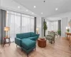 Living area featuring a wall of windows, recessed lighting, and light wood-style floors Living area featuring a wall of windows, recessed lighting, and light wood-style floors