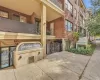 Brick exterior featuring a concrete facade, covered terrace, decorative column, and iron railings Brick exterior featuring a concrete facade, covered terrace, decorative column, and iron railings