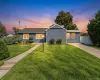 Ranch-style exterior featuring blue shake siding, architectural shingle roof, concrete driveway, front walkway, and mature landscaping Ranch-style exterior featuring blue shake siding, architectural shingle roof, concrete driveway, front walkway, and mature landscaping