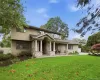Exterior facade featuring stone veneer detailing, shingle-style siding, a covered entryway with column supports, and a paved walkway Exterior facade featuring stone veneer detailing, shingle-style siding, a covered entryway with column supports, and a paved walkway