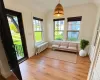 Virtually Staged. Doorway featuring radiator, light hardwood / wood-style floors, and plenty of natural light Virtually Staged. Doorway featuring radiator, light hardwood / wood-style floors, and plenty of natural light