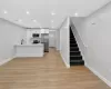 Open-concept living space with wood-finish flooring Open-concept living space with wood-finish flooring