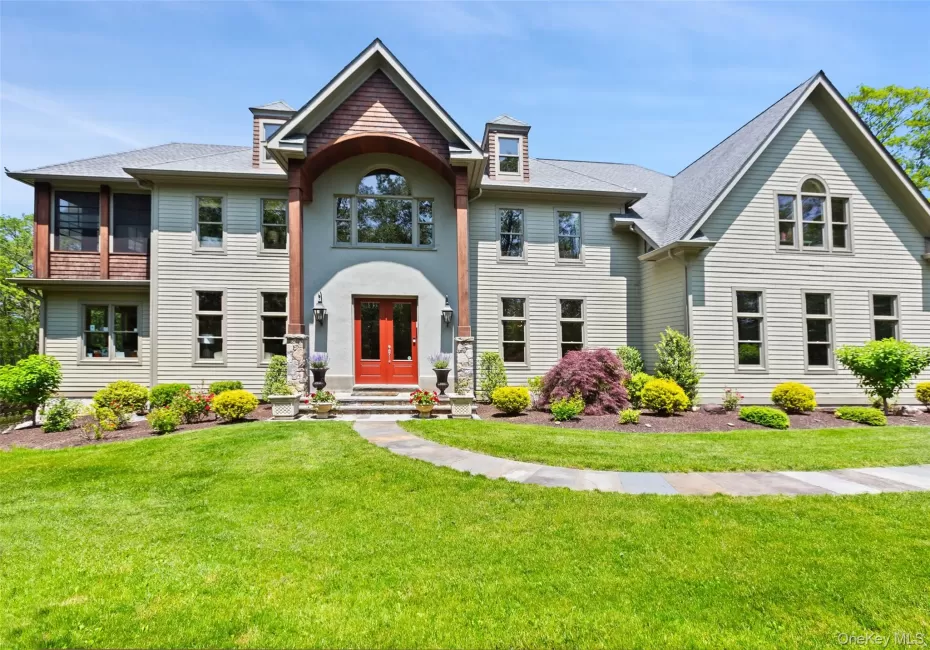 View of front facade featuring a front yard, a shingled roof, and french doors View of front facade featuring a front yard, a shingled roof, and french doors