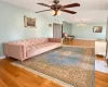 Hardwood flooring, multi-light ceiling fan, and crystal chandelier fixture Hardwood flooring, multi-light ceiling fan, and crystal chandelier fixture