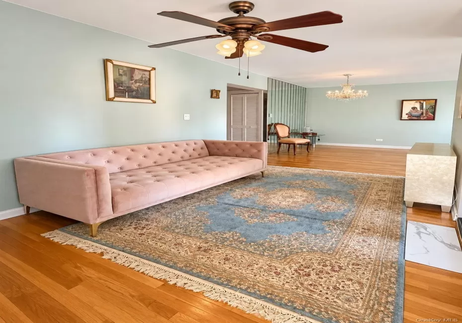 Hardwood flooring, multi-light ceiling fan, and crystal chandelier fixture Hardwood flooring, multi-light ceiling fan, and crystal chandelier fixture