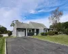 Single story home featuring a front yard, driveway, and an attached garage Single story home featuring a front yard, driveway, and an attached garage