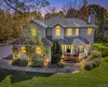Two-story residence featuring grey horizontal siding, a covered front porch with a white railing, an asphalt shingle roof, a stone-paver walkway. Two-story residence featuring grey horizontal siding, a covered front porch with a white railing, an asphalt shingle roof, a stone-paver walkway.