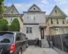 Two-story residence featuring stone-veneer cladding, a gabled roofline, concrete driveway, and covered front entryway with tiled steps Two-story residence featuring stone-veneer cladding, a gabled roofline, concrete driveway, and covered front entryway with tiled steps