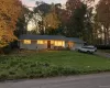 Ranch-style house with an attached garage, driveway, a lawn, and board and batten siding Ranch-style house with an attached garage, driveway, a lawn, and board and batten siding