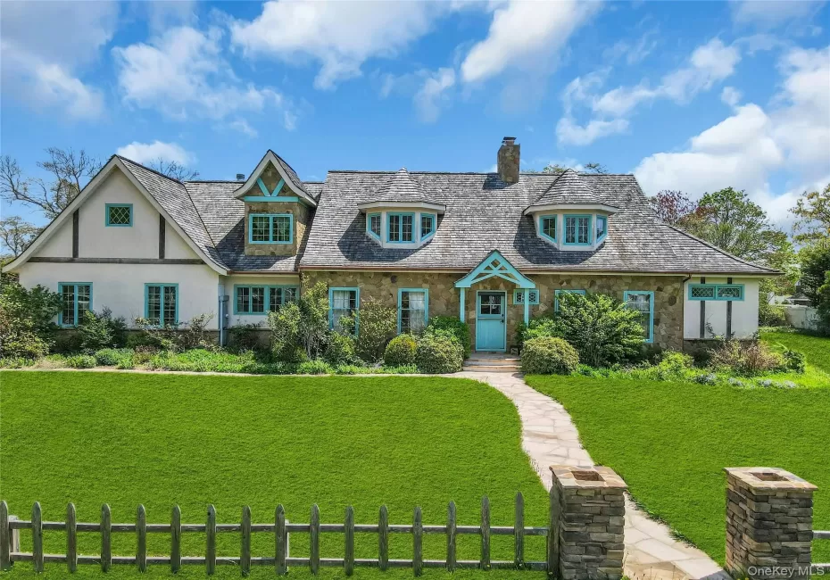 Stone and stucco exterior featuring a prominent teal front dutch door and complementary trim Stone and stucco exterior featuring a prominent teal front dutch door and complementary trim