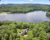 Drone / aerial view of a forest and a nearby body of water Drone / aerial view of a forest and a nearby body of water