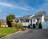 Ranch-style house with roof with shingles and a chimney Ranch-style house with roof with shingles and a chimney