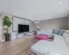 Living area featuring light wood-type flooring, recessed lighting, a wall mounted air conditioner, and vaulted ceiling Living area featuring light wood-type flooring, recessed lighting, a wall mounted air conditioner, and vaulted ceiling