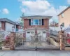 View of front facade with a gate and brick siding View of front facade with a gate and brick siding
