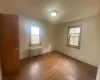 Empty room with baseboards, radiator heating unit, and dark wood-style floors Empty room with baseboards, radiator heating unit, and dark wood-style floors