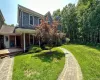 View of front of house featuring a chimney and a front lawn View of front of house featuring a chimney and a front lawn