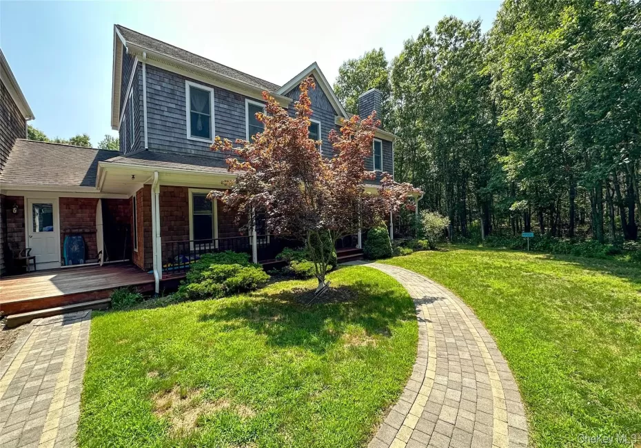 View of front of house featuring a chimney and a front lawn View of front of house featuring a chimney and a front lawn