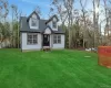 Cape cod-style house featuring a shingled roof and a front lawn Cape cod-style house featuring a shingled roof and a front lawn