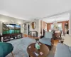 Living area with wood finished floors, a chandelier, and decorative columns Living area with wood finished floors, a chandelier, and decorative columns