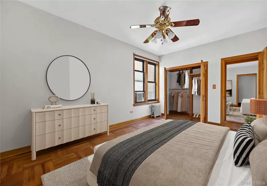 Bedroom featuring a ceiling fan, a closet, and radiator heating unit Bedroom featuring a ceiling fan, a closet, and radiator heating unit