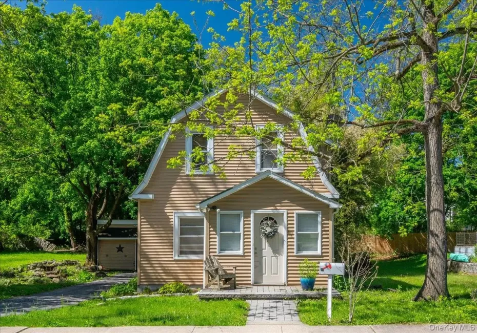 Two-story property featuring horizontal siding and a gambrel roofline Two-story property featuring horizontal siding and a gambrel roofline