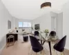 Virtually stages living room/dining area featuring baseboards and light wood-type flooring Virtually stages living room/dining area featuring baseboards and light wood-type flooring