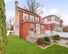 View of front of property featuring a chimney and brick siding View of front of property featuring a chimney and brick siding