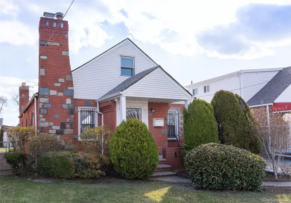View of front of house with brick siding and a chimney View of front of house with brick siding and a chimney