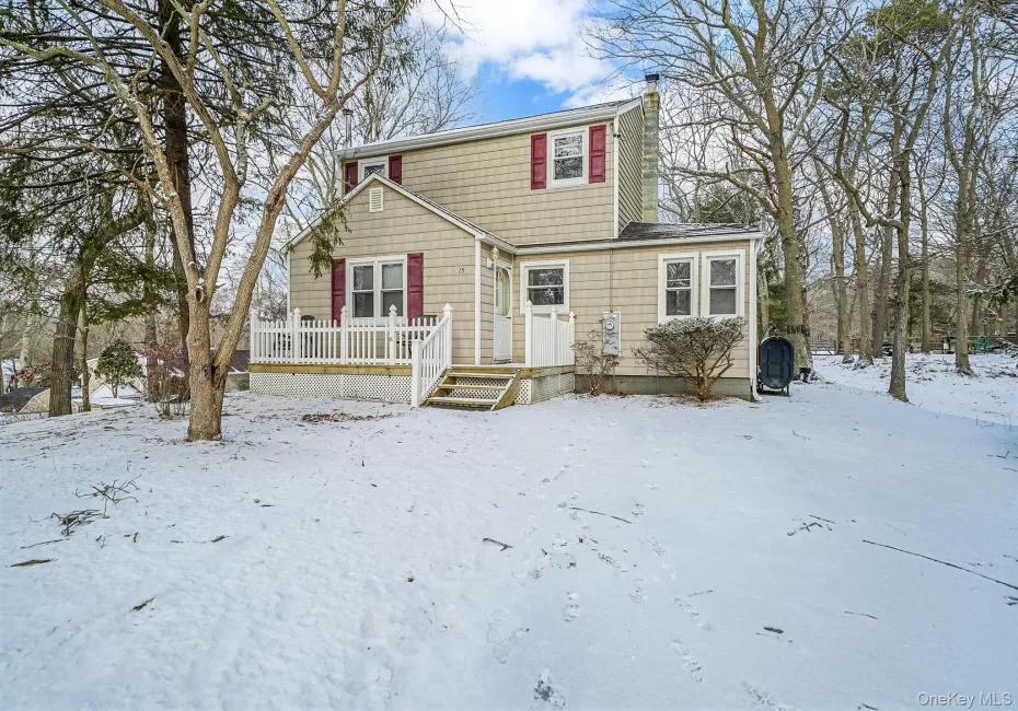 View of front of property featuring a wooden deck, a chimney, and heating fuel View of front of property featuring a wooden deck, a chimney, and heating fuel