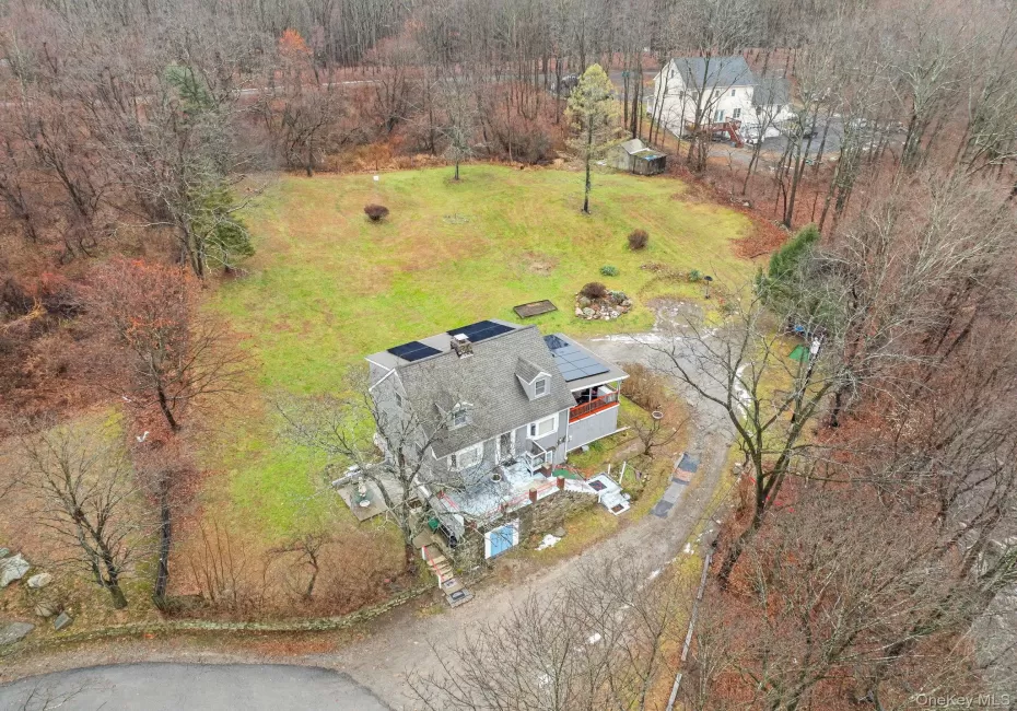 Aerial view of property and surrounding area featuring a forest Aerial view of property and surrounding area featuring a forest