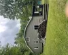 Rear view of house with a yard, a deck, and a chimney Rear view of house with a yard, a deck, and a chimney