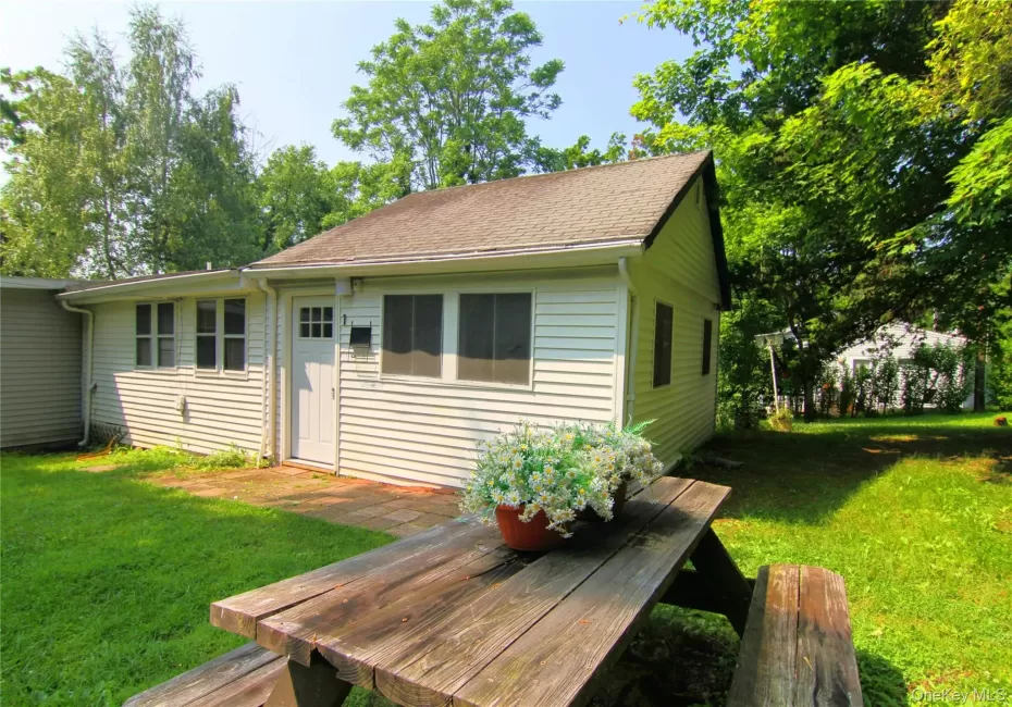 Wooden terrace featuring a yard Wooden terrace featuring a yard