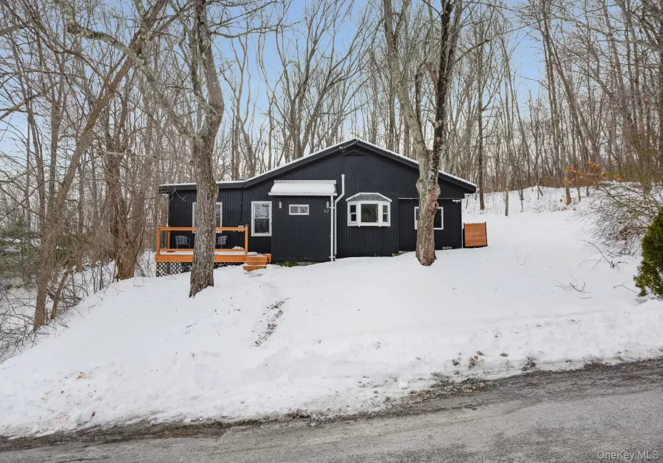 View of snowy exterior with a deck View of snowy exterior with a deck