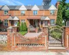 Townhome / multi-family property with brick siding and a gate Townhome / multi-family property with brick siding and a gate