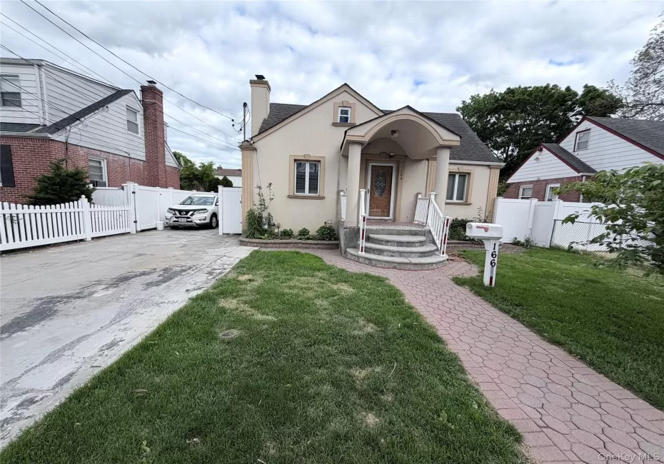 Charming stucco exterior with a covered entryway and arched portico Charming stucco exterior with a covered entryway and arched portico