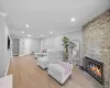 Living area featuring light-toned wood-finish flooring, recessed lighting, and crown molding Living area featuring light-toned wood-finish flooring, recessed lighting, and crown molding