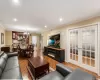 Open-concept living space featuring wood-finish flooring, recessed lighting, and crown molding Open-concept living space featuring wood-finish flooring, recessed lighting, and crown molding