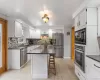 Main floor kitchen. Updated with Quartz countertop center island and stainless steel appliances including 5 burner gas cooktop. Main floor kitchen. Updated with Quartz countertop center island and stainless steel appliances including 5 burner gas cooktop.