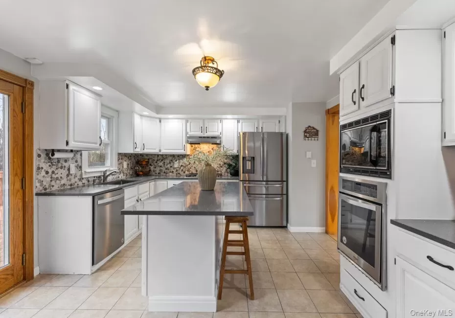 Main floor kitchen. Updated with Quartz countertop center island and stainless steel appliances including 5 burner gas cooktop. Main floor kitchen. Updated with Quartz countertop center island and stainless steel appliances including 5 burner gas cooktop.