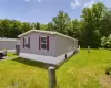 View of side of property featuring a lawn View of side of property featuring a lawn
