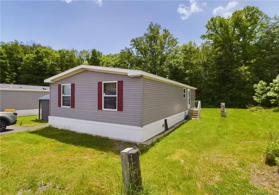 View of side of property featuring a lawn View of side of property featuring a lawn