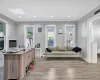 Office space featuring light wood-style floors, crown molding, recessed lighting, a skylight, and baseboard heating Office space featuring light wood-style floors, crown molding, recessed lighting, a skylight, and baseboard heating