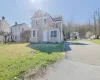 Traditional home with a front lawn and aphalt driveway Traditional home with a front lawn and aphalt driveway