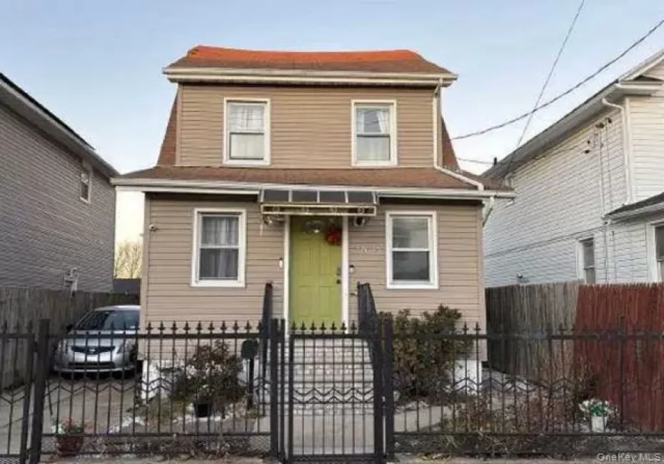 View of front of property featuring a fenced front yard and a gate View of front of property featuring a fenced front yard and a gate