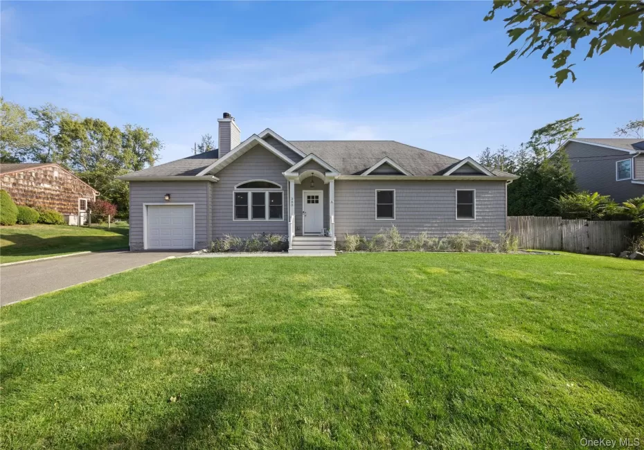 Single story home featuring concrete driveway, a chimney, a shingled roof, and a garage Single story home featuring concrete driveway, a chimney, a shingled roof, and a garage