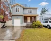 View of front facade with a porch, concrete driveway, and a garage View of front facade with a porch, concrete driveway, and a garage