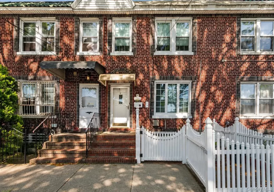 Brick facade townhome featuring multiple windows Brick facade townhome featuring multiple windows