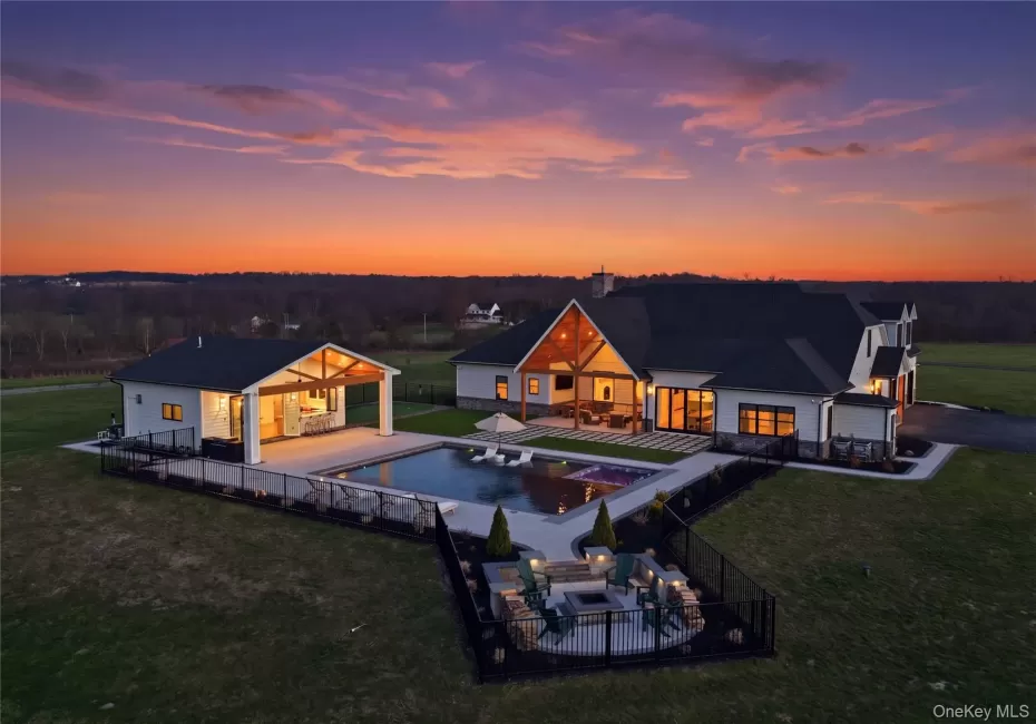 Modern exterior featuring white siding, dark roofing, and exposed wood beam accents Modern exterior featuring white siding, dark roofing, and exposed wood beam accents