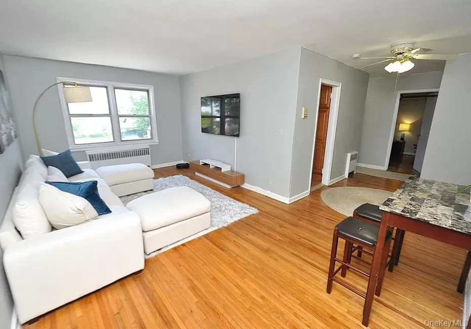 The large living room has hardwood floors and opens to the dining are and entry foyer. The living area and dining area is approx 20'-4" x 11'-5". The large living room has hardwood floors and opens to the dining are and entry foyer. The living area and dining area is approx 20'-4" x 11'-5".