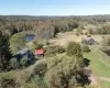 View from above of property with a pond and a wooded area View from above of property with a pond and a wooded area